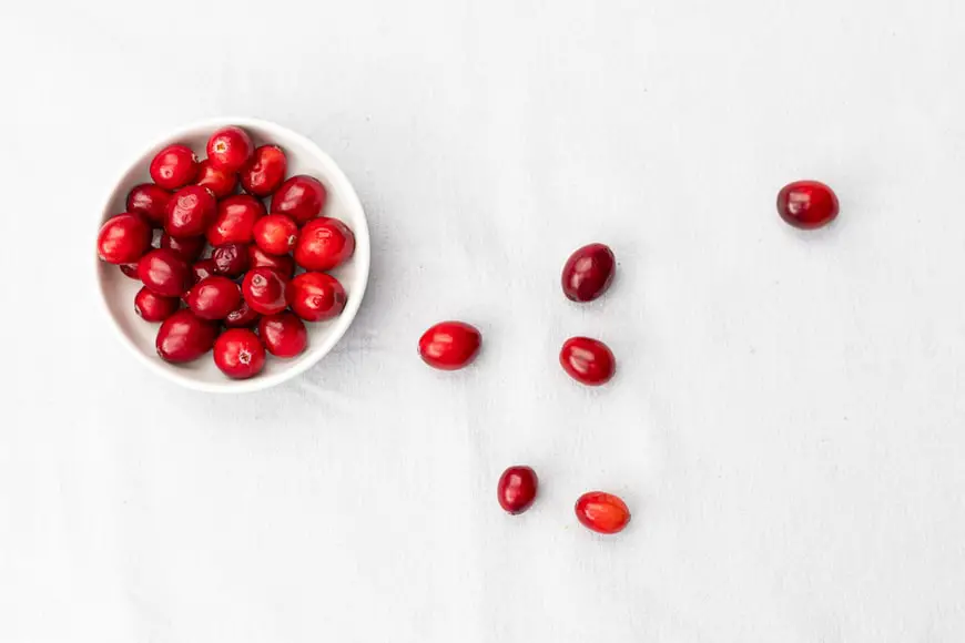 Cranberries are a small edible berry with a bright red color.